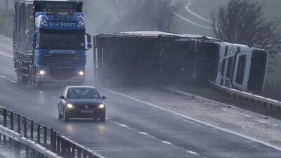 An overturned lorry lies on the hard shoulder of the M9 near Stirling in Scotland. Russell Cheyne / Reuters