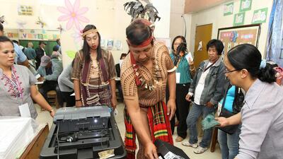 Filipino Nicolas Cawed, centre, chieftain of an Igorot Tribe, casts his vote inside a polling centre in the mountainous village of Baguio City, Philippines. Over 54 million eligible Filipinos vote for a new president, vice president, 12 senators and more than 18,000 regional and local positions. EPA / STR