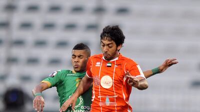 Ajman's Ali Khamis Mohamed looks to control the ball during the Semi-Final Pro League football match between Al Shabab (green) v Ajman (orange) at Shabab's Maktoum Bin Rashid Al Maktoum Stadium on 25.03.2013. Ashraf Umrah / Al Ittihad