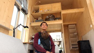 Van Bo Le-Mentzel, head of the Tiny House University Project, sits inside a small house built on site for an exhibition at the Bauhaus-Archiv museum of Design in Berlin, on June 6, 2017. Adam Berry / AFP