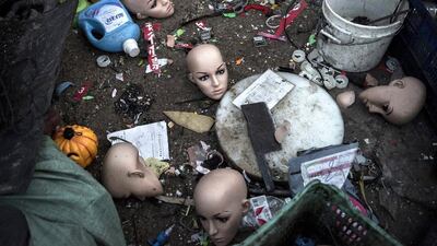 Plastic mannequin heads and other items lay on the ground before being recycled in the Dong Xiao Kou village. Kevin Frayer / Getty Images