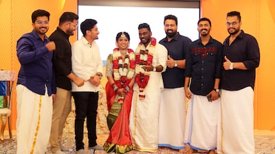 Friends pose for photographs with the couple