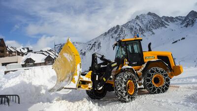 A tractor shifts snow at La Mongie ski resort in the Hautes Pyrenees region in Grand Tourmalet, France. France’s winter resorts are taking the government to court to keep ski lifts operating. Bloomberg