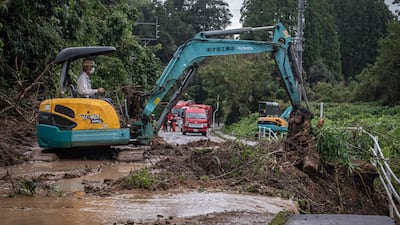 Heavy machinery is used to clears debris and mud from a road in Mimata. AFP