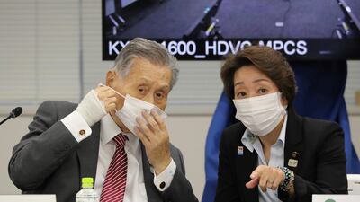 Former Tokyo 2020 Organising Committee President Yoshiro Mori, left, talks to Seiko Hashimoto, then Minister for the Tokyo Olympic and Paralympic Games, in Tokyo, on September 24, 2020. Ms Hashimoto replaced Mr Mori, who was forced to resign last week after he made demeaning comments about women. AP