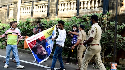 People with banners of Bollywood actor Shah Rukh Khan and his son Aryan Khan gather outside Aryan's residence in Mumbai to celebrate his release from jail on bail. All photos: AFP