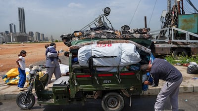 A displaced family pack their belongings at a displacement camp in Beirut, before returning to their home in southern Lebanon. Getty Images