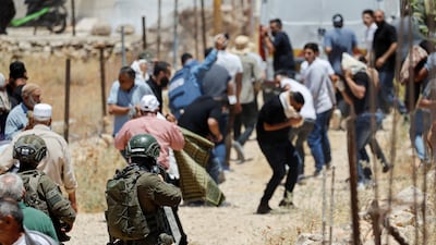 Israeli troops fire tear gas as Palestinians hold Friday prayers during a protest against Israeli settlement expansion and land confiscation near Bethlehem, in the Israel-occupied West Bank, on July 3. Reuters