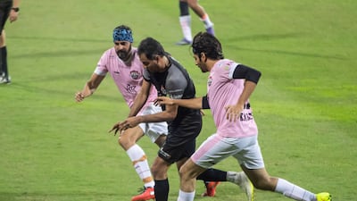 Kartik Aaryan, far right, battling for the ball.