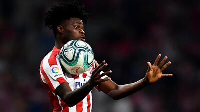 Atletico Madrid's Ghanaian midfielder Thomas Partey jumps for the ball during the Spanish league football match between Club Atletico de Madrid and Real Madrid CF at the Wanda Metropolitano stadium in Madrid on September 28, 2019. / AFP / OSCAR DEL POZO