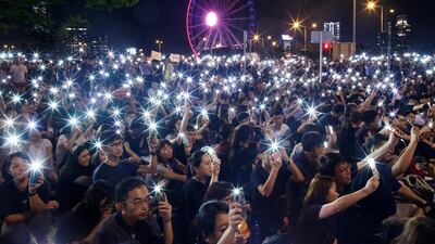 Demonstrators wave their smartphones during a rally ahead of the G20 summit in Hong Kong, China. Reutrs