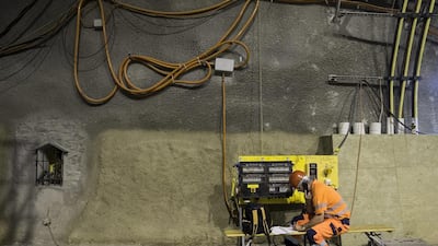 A construction worker telephoning in the Gotthard Base Tunnel. Alexandra Wey / EPA