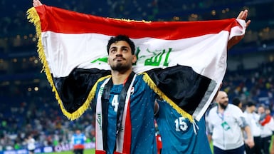 Soccer Football - FIFA World Cup - Inter-Confederation Playoffs - Final - Iraq v Bolivia - Estadio Monterrey, Monterrey, Mexico - March 31, 2026 Iraq's Zaid Tahseen celebrates with the national flag after qualifying for FIFA World Cup REUTERS / Raquel Cunha