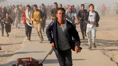 Palestinians rush to collect aid supplies from the US-backed Gaza Humanitarian Foundation, in Khan Younis, in the southern Gaza Strip. Reuters