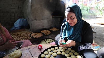 An Egyptian woman prepares 'kahk', Egyptian butter cookies, in the village of Dalgamon, Tanta, some 120km north of Cairo, Egypt, 17 May. Egyptian Muslims prepare to celebrate Eid Al Fitr. Khaled Elfiqi / EPA