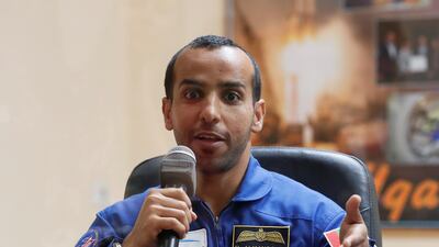 Hazza speaks from behind a glass wall during a final news conference. The crew are kept in quarantine for two weeks prior to the mission to reduce the chance of getting sick. Shamil Zhumatov / Reuters