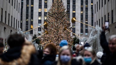 Tourists gather near the Christmas tree in Rockefeller Center in New York, n December 2. EPA
