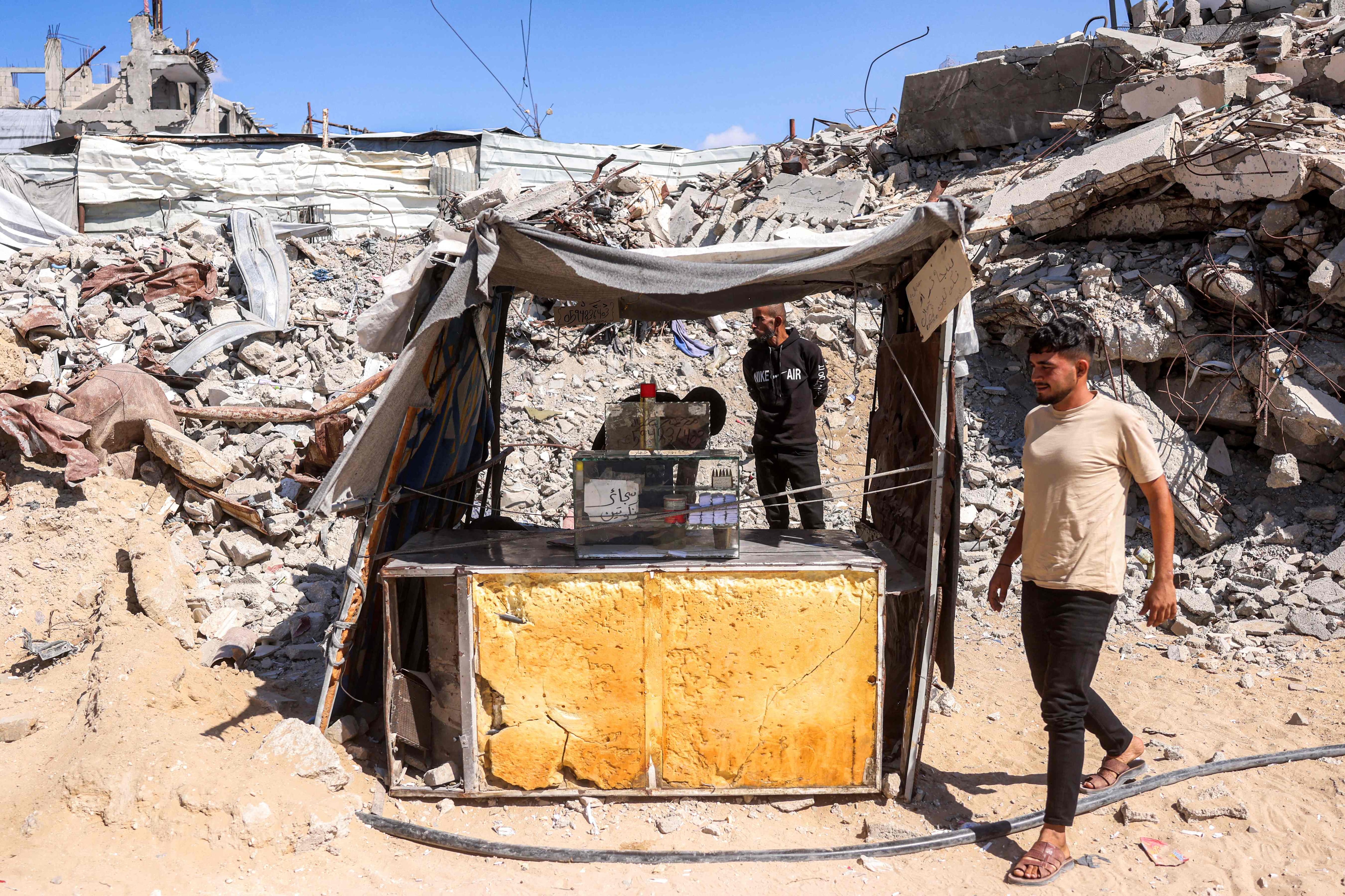 A Gazan man sells hand-rolled cigarettes at a stall in the Jabalia displacement camp. AFP