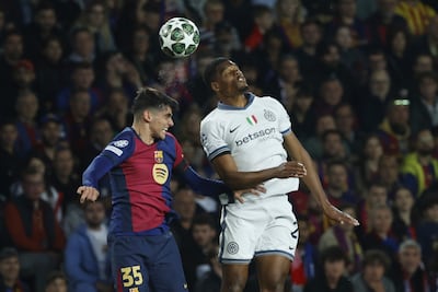 Barcelona's Gerard Martin, left, challenges Inter Milan's Denzel Dumfries. AP