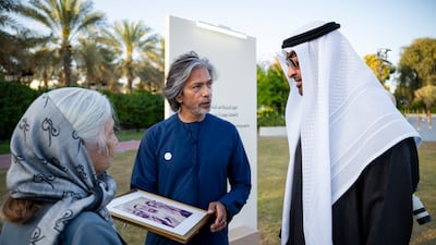 President Sheikh Mohamed views photographs from the day the UAE was founded, taken by Ramesh Shukla. All photos: UAE Presidential Court