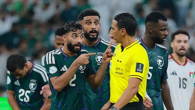 Saudi Arabia players complain with referee Jalal Jayed after UAE are awarded a penalty that would be overturned after VAR review. Reuters