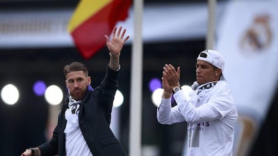 Real Madrid teammates Sergio Ramos, left, and Cristiano Ronaldo wave to the crowd during their team celebration at Cibeles square after winning the Uefa Champions League Final match against Atletico Madrid on May 29, 2016 in Madrid, Spain. Gonzalo Arroyo Moreno/Getty Images