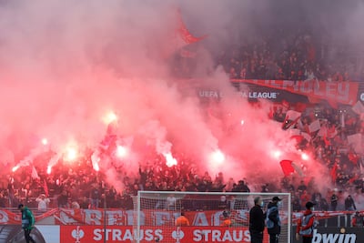 Fans light flares in the stands before a Europa League game between Royal Antwerp and Frankfurt at the redeveloped Bosuil Stadium in September, 2021. AP