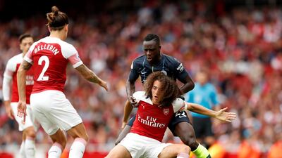 Manchester City’s Benjamin Mendy, dark blue kit, in action with Arsenal's Matteo Guendouzi. Reuters