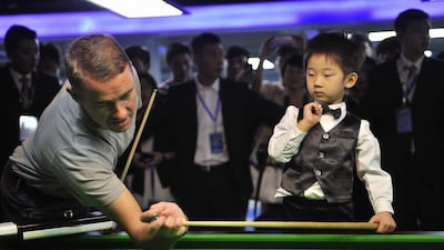 Hendry, 41 years his senior, has a bit of fun playing against Wuka, and while he is at it, passes along a few handy tips. An experience of a lifetime, surely. Reuters