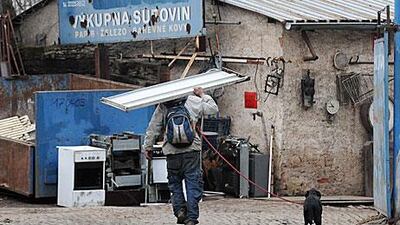 A Czech man brings a sheet of metal to a scrapyard in Prague. Metal thieves have taken advantage of lax laws by stealing metal and selling it for profit.