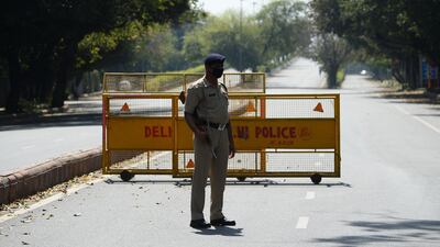 A policeman stands guard at a checkpoint the day after Indian Prime Minister Narendra Modi announced a 21-day government-imposed nationwide lockdown, in New Delhi. AFP
