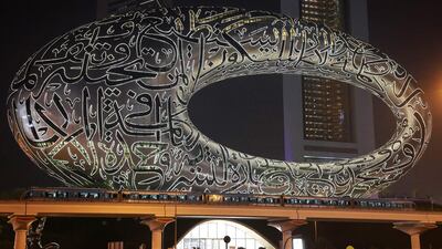 A Dubai Metro train passes the Museum of the Future on Sheikh Zayed Road in Dubai. September 9, 2024, will be Dubai Metro’s 15th Anniversary. Pawan Singh / The National