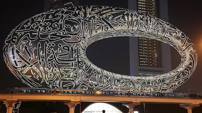 A Dubai Metro train passes the Museum of the Future on Sheikh Zayed Road in Dubai. September 9 was Dubai Metro’s 15th Anniversary. Pawan Singh / The National