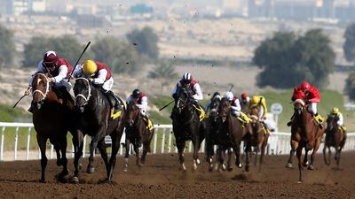 Pat Dobbs, second from left, guides Henry Clay to victory in the 1,800m handicap at Jebel Ali racecourse in Dubai on Friday. Pawan Singh / The National