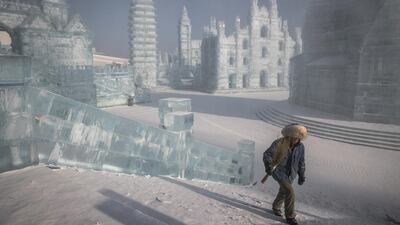 A worker walks next to the ice sculptures. EPA