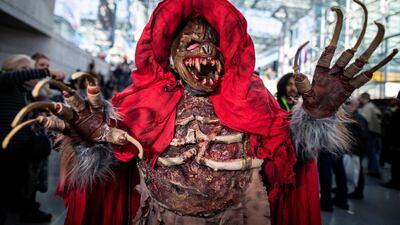 An attendee dressed as the monster from 'The Village' poses during New York Comic Con at the Jacob K.Javits Convention Center in New York. AP