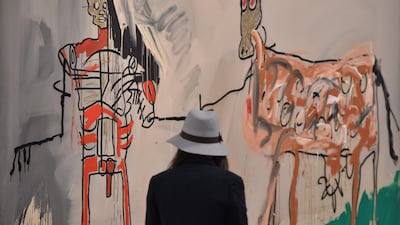 A woman visits the exhibition "Jean-Michel Basquiat", a retrospective on Jean-Michel Basquiat’s career from graffiti in New York to more complex work. AFP