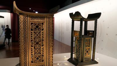 The 19th century throne of King Ghezo, left, and the throne of King Glele, from Benin, are part of the exhibit. AP