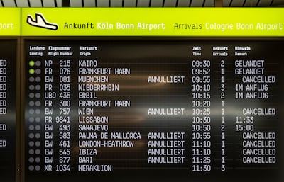 A display at Cologne Bonn Airport shows delays and flight cancellations. DPA