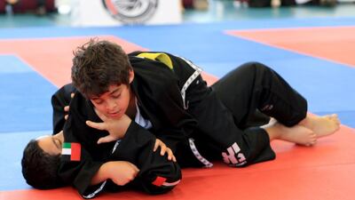 Winner Saif al Mohair from Al Muna School (top) fights Saif al Hebsi from Al Mushrif School in the preliminary fights yesterday at Aldar Academies Jiu Jitsu Cup 2015 at Aldar Academies Al Bateen Secondary School in Abu Dhabi. Ravindranath K / The National