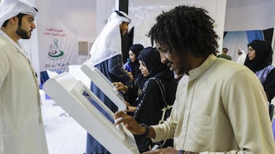 Saeed Khames, 21, a student from Fujairah, fills in an application to be considered for employment at the Bank of Fujairah. Antonie Robertson / The National
