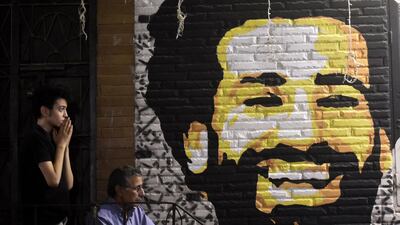 A man reacts as he watches the the UEFA Champions League final football match, between Real Madrid and Liverpool, at a coffee shop in the Egyptian capital Cairo on May 26, 2018. On the wall is a painting of Liverpool Egyptian forward Mohamed Salah. Liverpool suffered the loss of 44-goal top scorer Mohamed Salah to a shoulder injury on 31 minutes, after a tangle with Real defender Sergio Ramos. Khaled Desouki / AFP