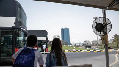 Commuters wait for a bus at Sharjah’s Al Jubeil bus station. Plans are afoot to install 172 air-conditioned bus stops in the emirate. Victor Besa for The National