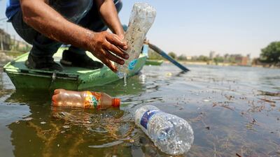 Saad Hassanein, a 46-year-old fisherman, collects discarded plastic bottles from the Nile river in Giza, Egypt. Reuters