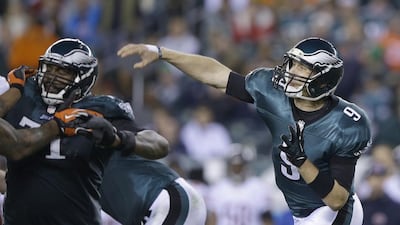 Philadelphia quarterback Nick Foles, right, has taken care of the ball for the Eagles this year. Michael Perez / AP Photo