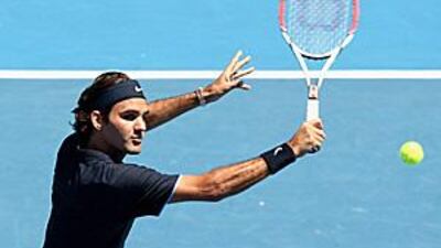 Roger Federer plays a backhand volley during his final victory over compatriot Stanislas Wawrinka at the Kooyong Lawn Tennis Club.