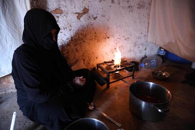 Um Samer, a displaced woman from eastern Ghouta, prepares an iftar meal in Maarrat Misrin, seven kilometres north of Idlib. AFP