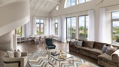 The four-bedroom apartment contains a double-height reception room as both its focal point and the main entertaining space, with a bespoke chandelier and dining space in one corner and a main seating. Courtesy CPC Group