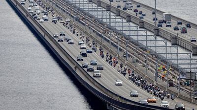 Hundreds of motorbikes are ridden across a bridge in Seattle, Washington state, in a show of solidarity with Boeing staff gathering to vote on strike action. AP