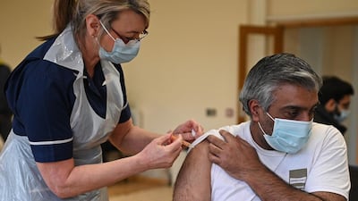 Nurse Maggie Clark administers a dose of the AstraZeneca/Oxford Covid-19 vaccine to a patient at a vaccination centre set up at the Fiveways Islamic Centre and Mosque in Nottingham, central England. AFP